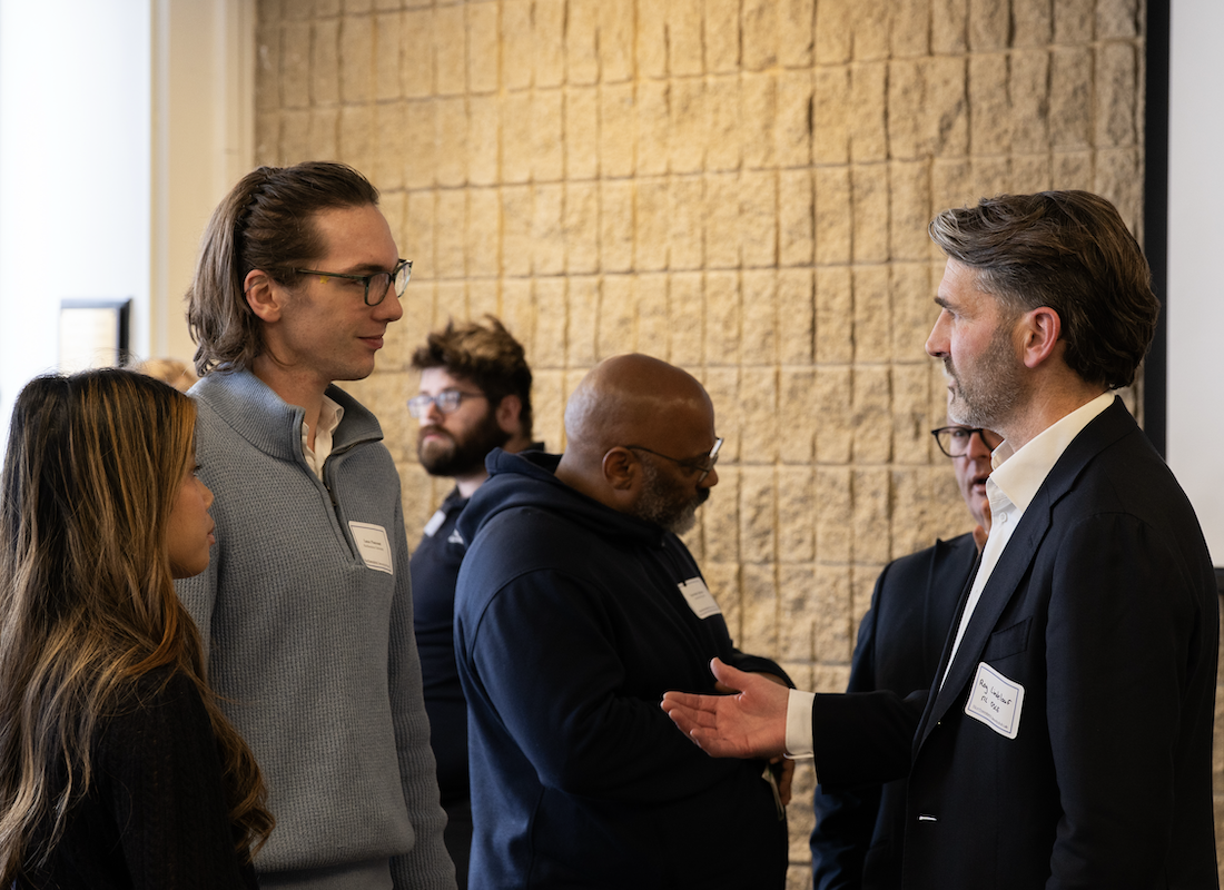 Students speaking with a recruiter at an event